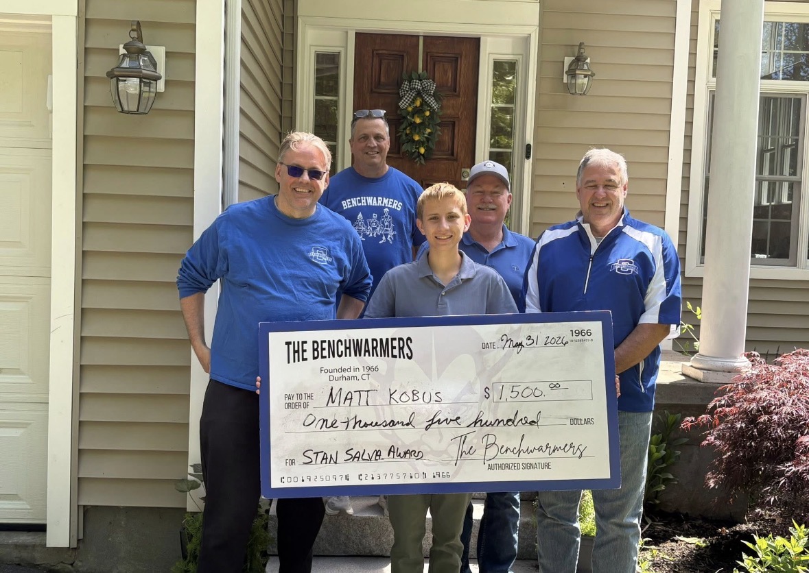 Coginchaug Benchwarmers celebrating a scholarship recipient
