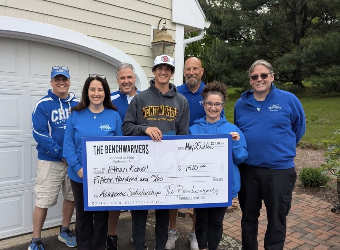Coginchaug Benchwarmers scholarship recipient holding a presentation check